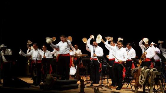 Foto de los músicos de la Banda de Guanacaste saludando al público desde un escenario